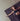 woman laying down in shavasana on Rituil™ recycled cotton yoga rug in ash or black color #color_ash