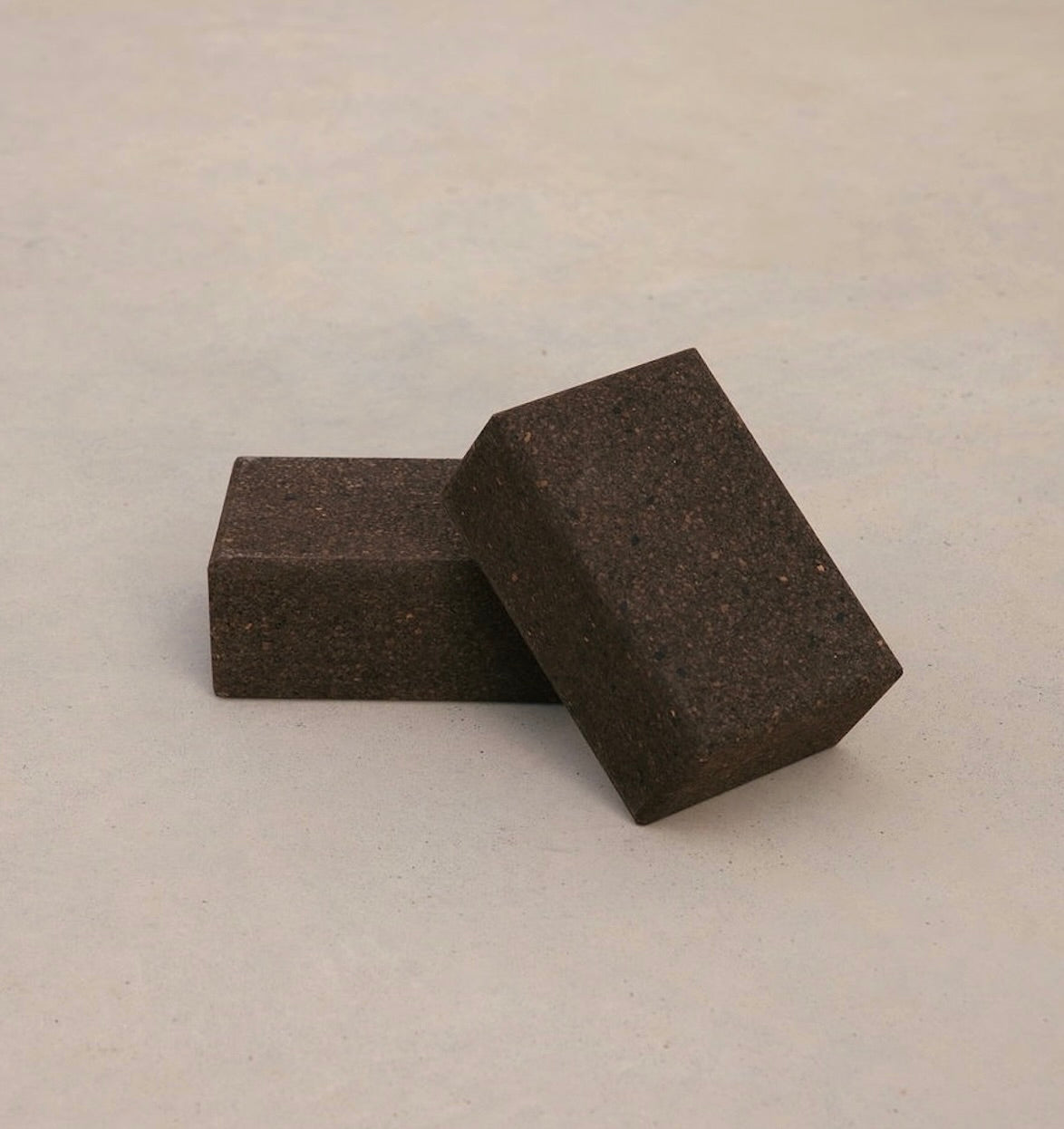 Two sustainable natural brown cork yoga blocks from Rituil, ideal for yoga and pilates practice and stretching exercises. #color_earth