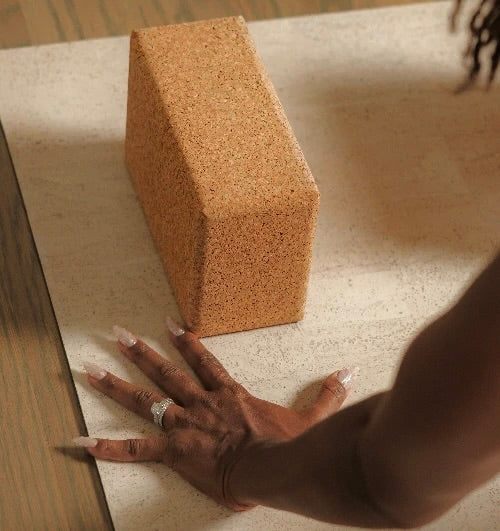 sustainable natural cork yoga blocks from Rituil, ideal for yoga and pilates practice and stretching exercises pictured with woman practicing yoga #color_sand