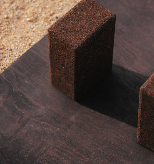 Close-up of a dark brown cork yoga mat and cork yoga blocks #color_earth