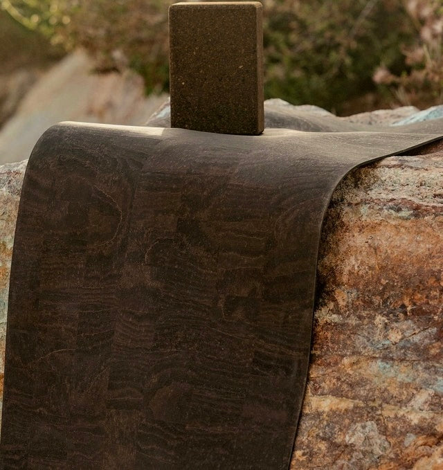 Rituil cork leather yoga mat and cork block folded over rock