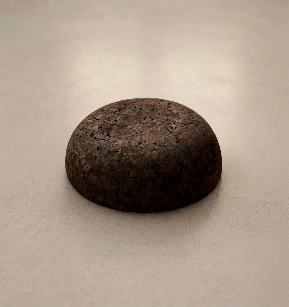 Rituil Meditation Seat made from sustainable natural cork in an earth tone resting on a concrete floor.