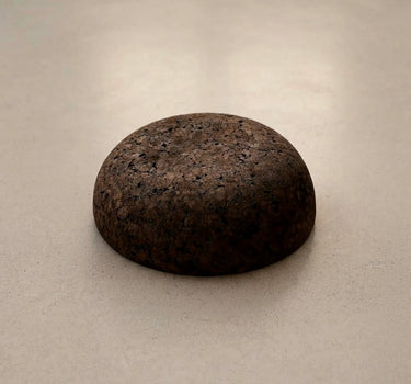 Rituil Meditation Seat made from sustainable natural cork in an earth tone resting on a concrete floor.