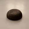 Rituil Meditation Seat made from sustainable natural cork in an earth tone resting on a concrete floor.
