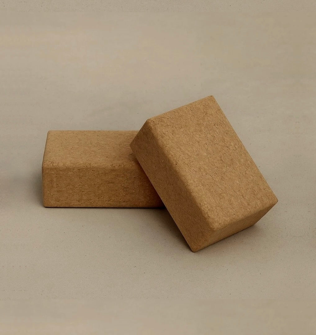 Two sustainable natural cork yoga blocks from Rituil on concrete floor #color_sand
