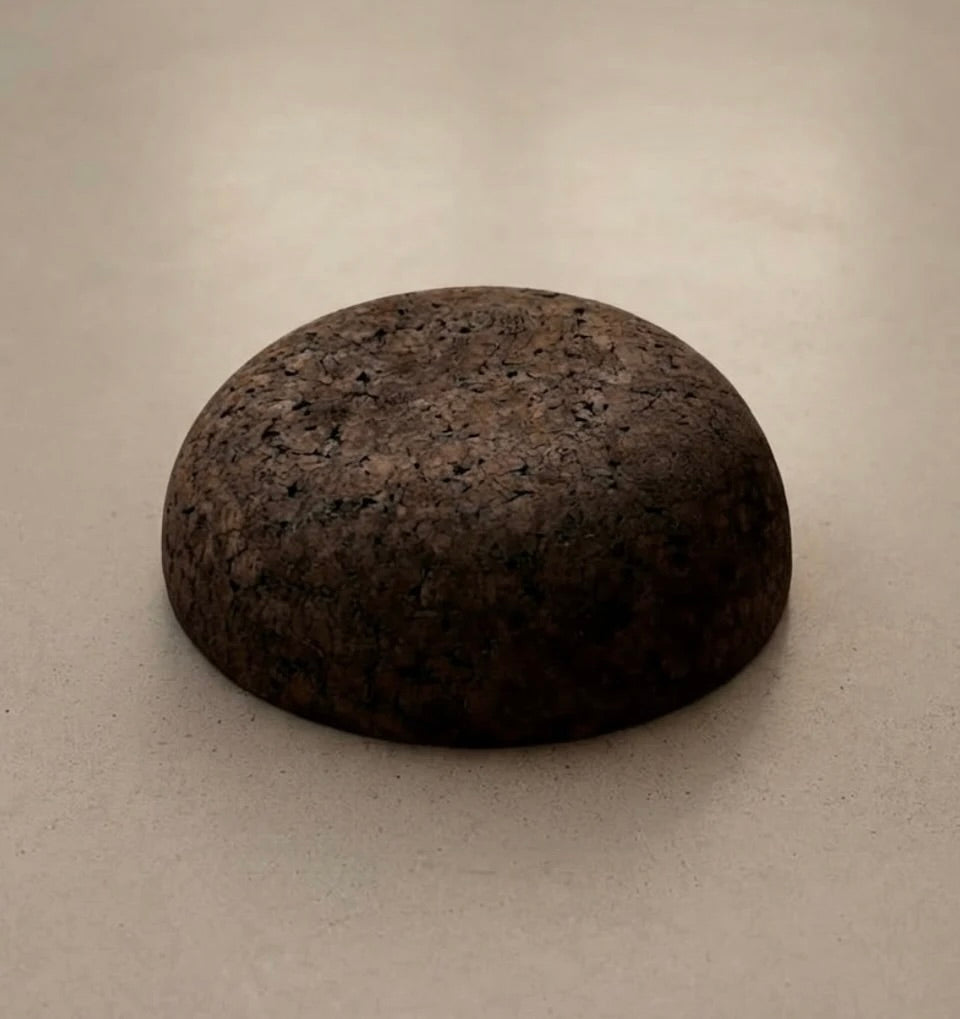 Rituil Meditation Seat made from sustainable natural cork in an earth tone resting on a concrete floor.