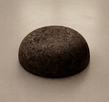 Rituil Meditation Seat made from sustainable natural cork in an earth tone resting on a concrete floor.