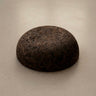 Rituil Meditation Seat made from sustainable natural cork in an earth tone resting on a concrete floor.