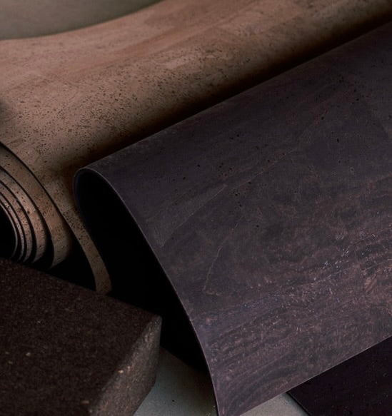 Rituil sustainable natural brown and tan cork leather yoga mats featuring a non-slip, non-toxic, pvc free, rolled up on floor