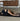 woman in childs pose on Rituil non slip natural ash or black cork yoga mat #color_ash