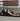 woman in childs pose on Rituil non slip natural ash or black cork yoga mat #color_ash