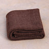 folded Rituil natural non slip recycled cotton yoga rug in earth or brown color #color_earth