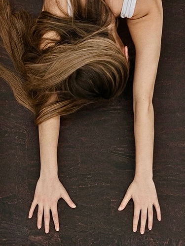 Cork yoga mat non-slip grip brown Rituil with woman in childs pose