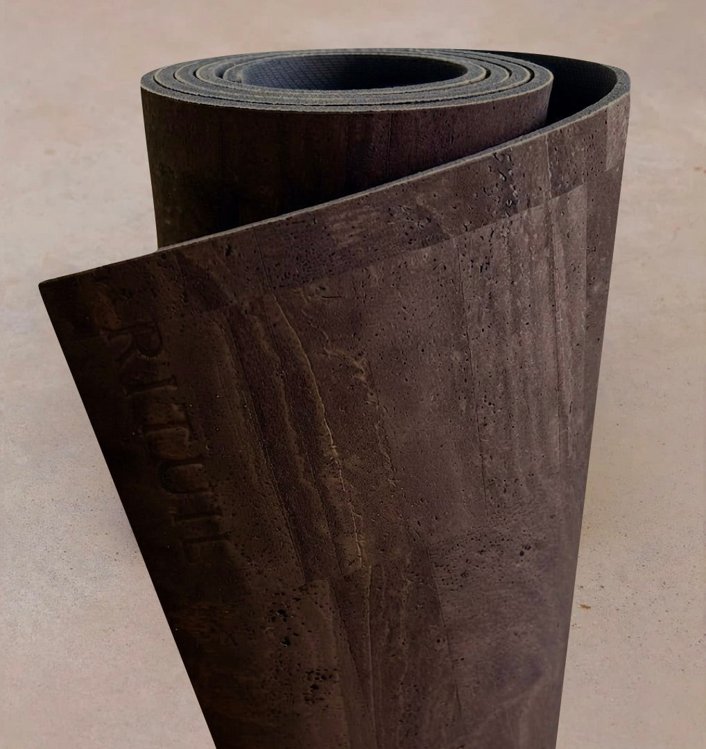 Extra long 6mm thick Rituil cork leather studio mat rolled in a rich dark brown colorway, showcasing sustainable Portuguese craftsmanship.