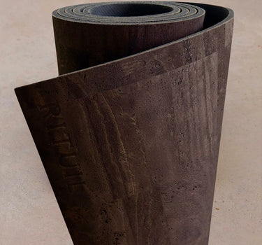 Extra long 6mm thick Rituil cork leather studio mat rolled in a rich dark brown colorway, showcasing sustainable Portuguese craftsmanship.