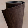Extra long 6mm thick Rituil cork leather studio mat rolled in a rich dark brown colorway, showcasing sustainable Portuguese craftsmanship.
