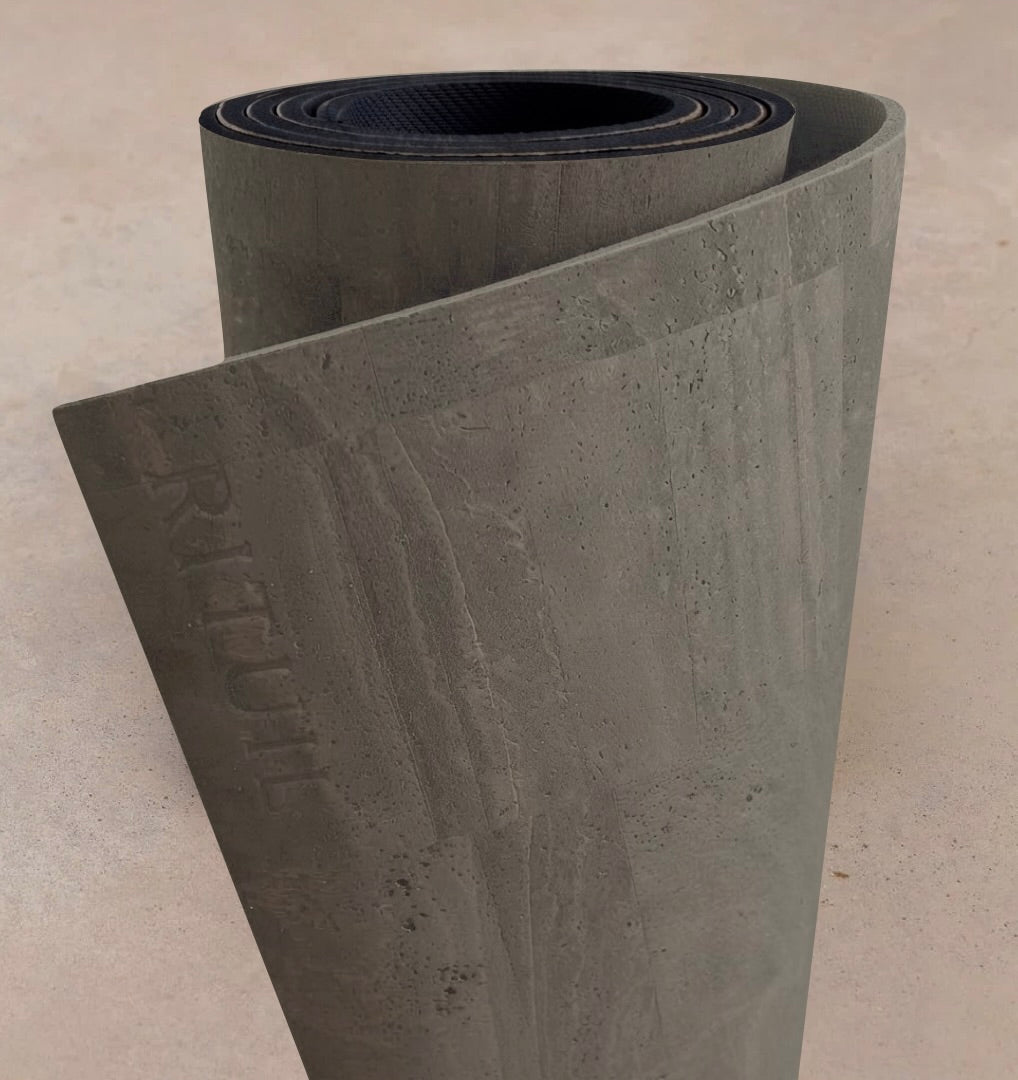 Extra long 6mm thick Rituil cork leather studio mat rolled in a natural grey colorway, designed for studio pilates and movement spaces.