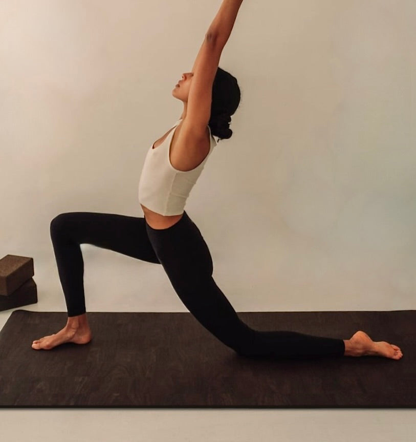 woman practicing yoga and pilates on extra long and extra thick brown cork yoga mat