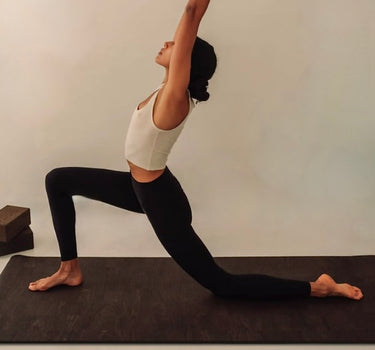 woman practicing yoga and pilates on extra long and extra thick brown cork yoga mat