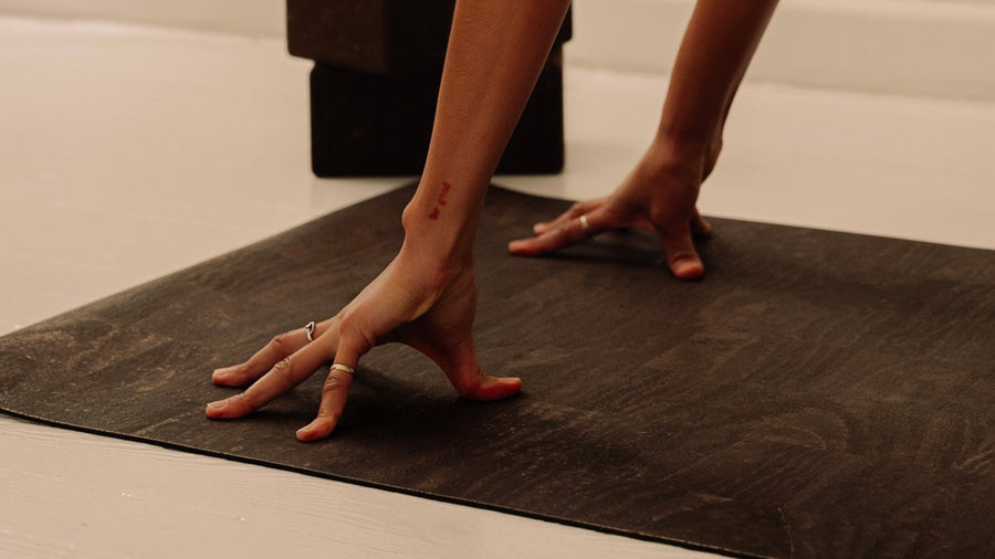 close up of woman practicing yoga on Rituil non-slip and non-toxic cork leather yoga mat brown.