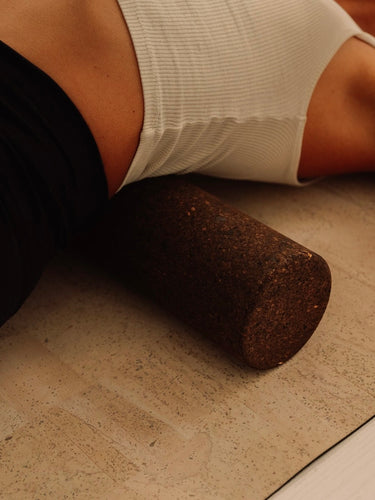 ustainable Portuguese cork massge roller for deep tissue muscle recovery shown on top of cork yoga mat