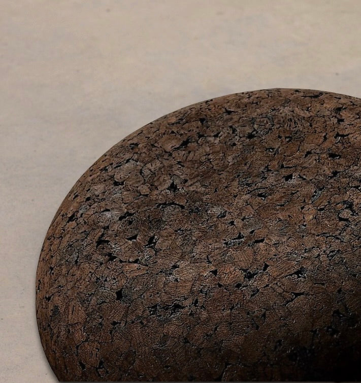 Close up of Rituil Meditation Seat made from sustainable natural cork in an earth tone resting on a concrete floor.
