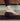 Person using a dark brown cork pea nut on a yoga mat 