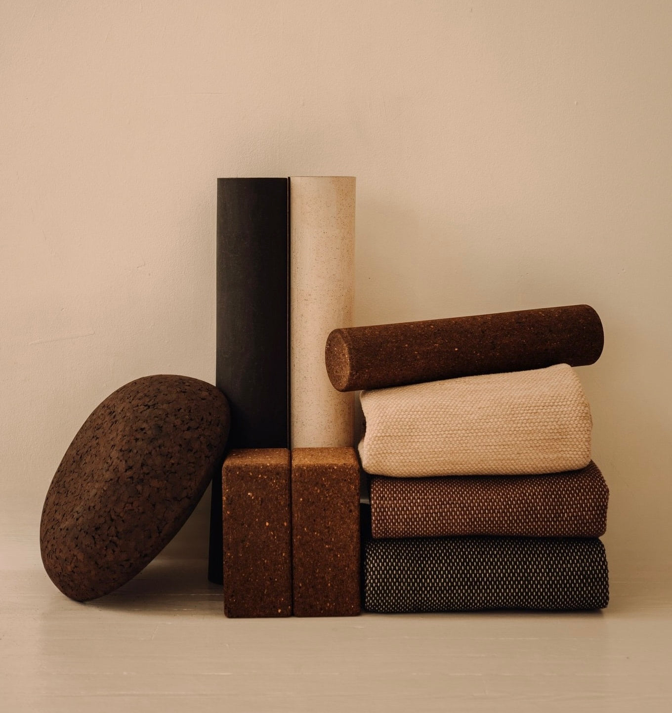 rituil cork yoga mats and blocks stacked against wall