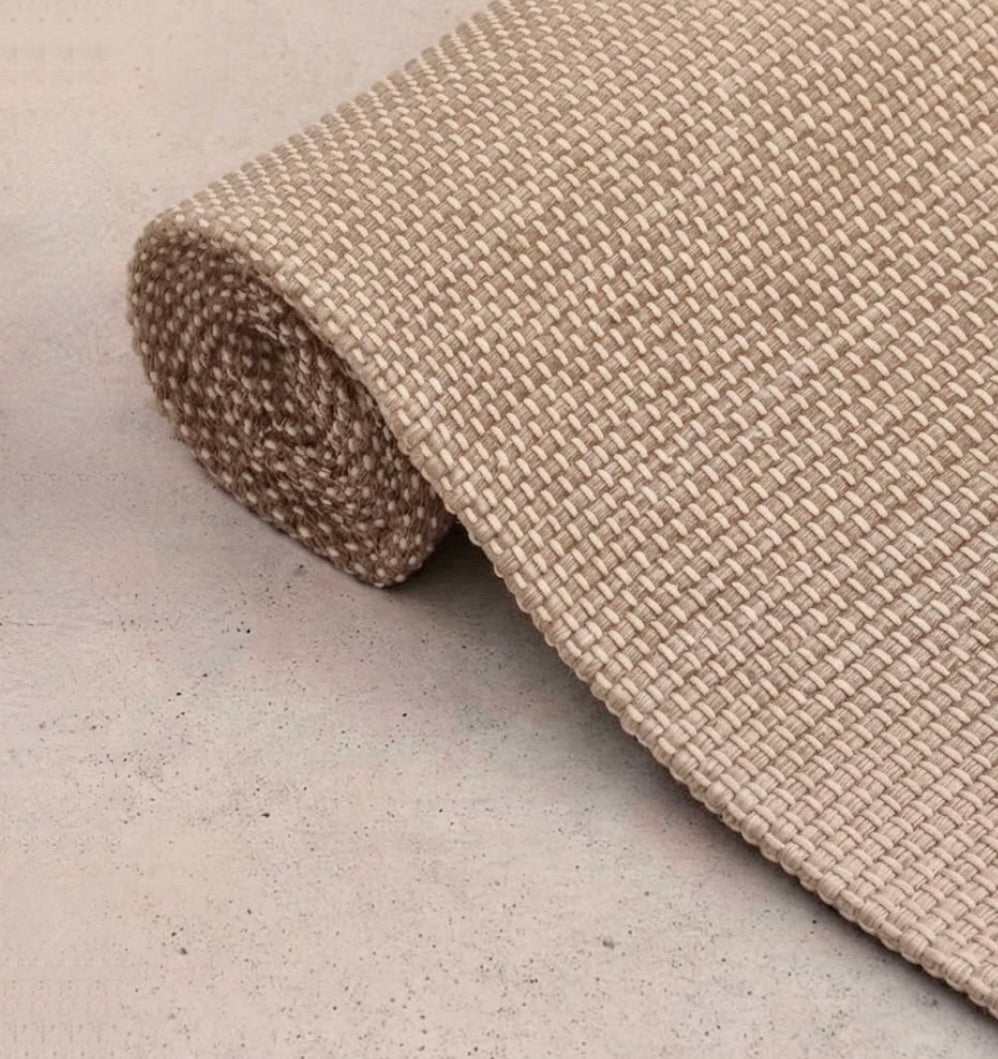 Rituil travel yoga rug in cream color, lightweight and portable, designed for yoga practice on the go.