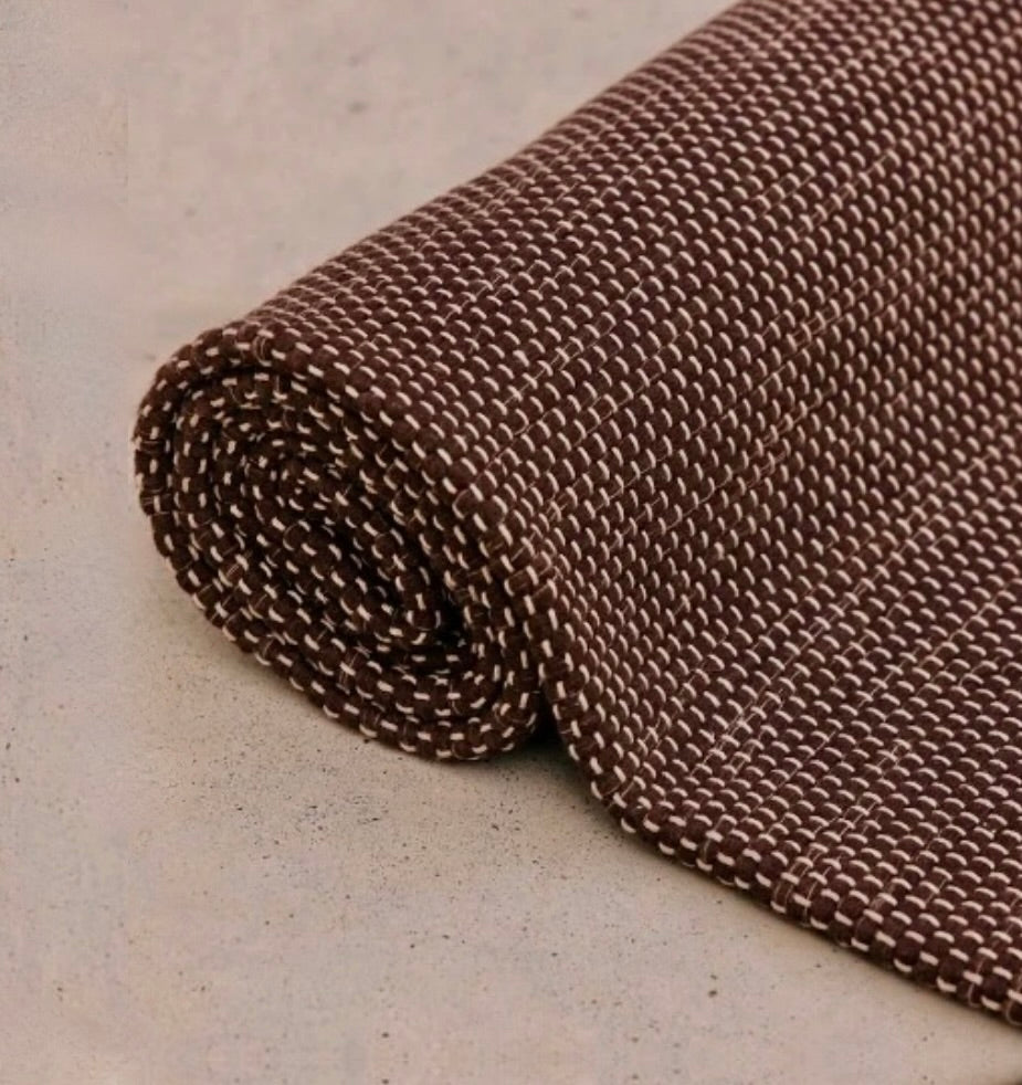 Rituil travel yoga rug in brown color, lightweight and portable, designed for yoga practice on the go.