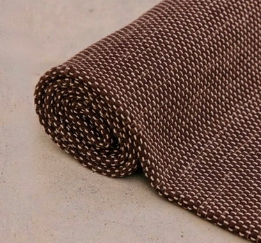 Rituil travel yoga rug in brown color, lightweight and portable, designed for yoga practice on the go.