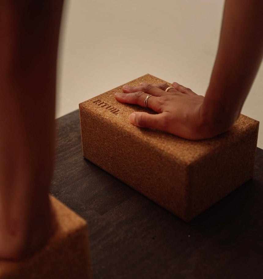 woman with hands on natural sustainable natural cork yoga blocks from Rituil