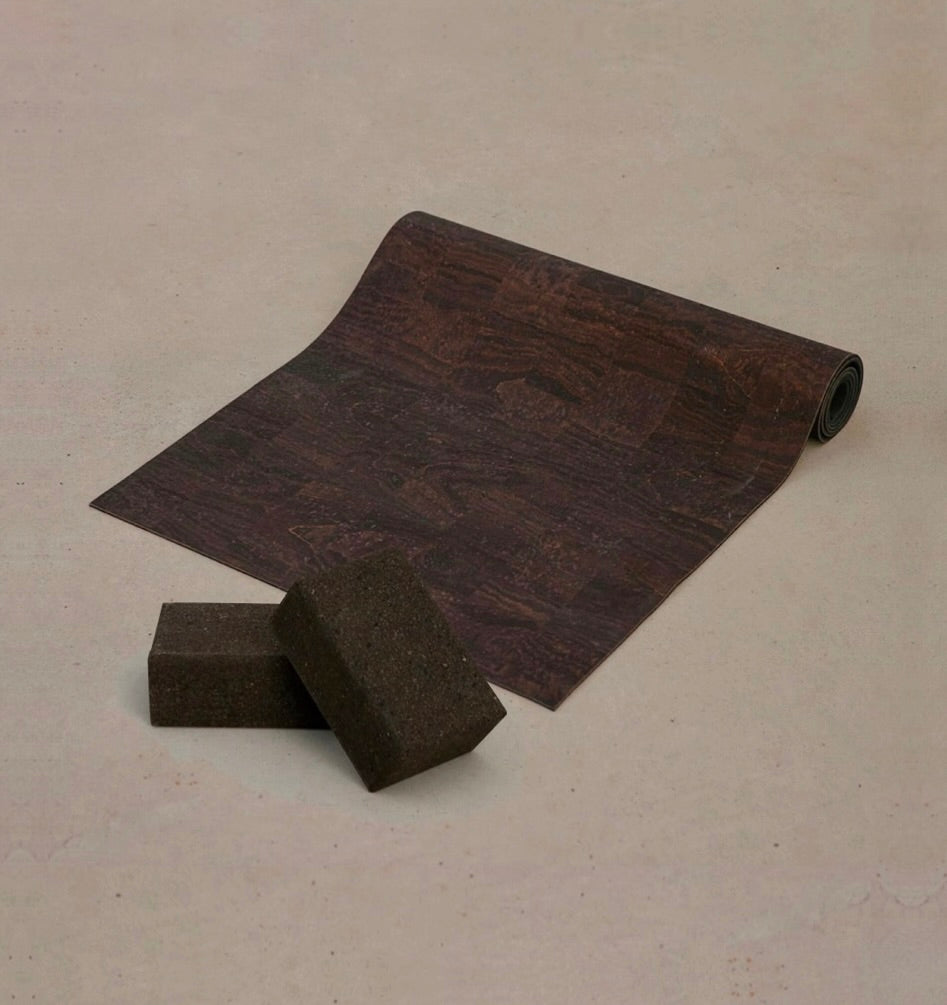 Rituil non slip and non toxic cork yoga mat and blocks set in brown color set on concrete floor