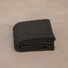 black non toxic restorative yoga rug  folded on concrete floor #color_ash