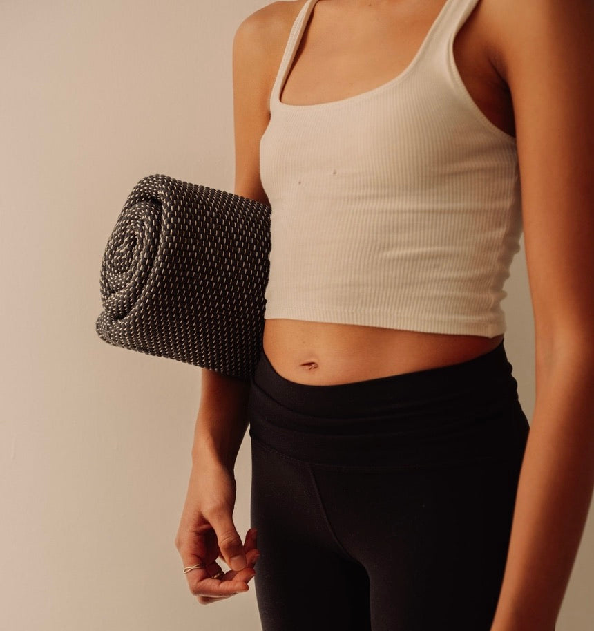 Rituil cotton travel yoga rug rituil rolled under womans arm