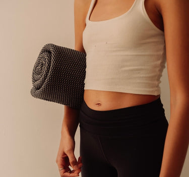 Rituil cotton travel yoga rug rituil rolled under womans arm