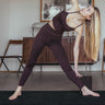 woman using earth or brown cork yoga blocks while doing yoga pose on Rituil™ cork yoga mat