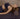 woman laying down on the Rituil™ ash colored rug with the restorative cork yoga block under her back