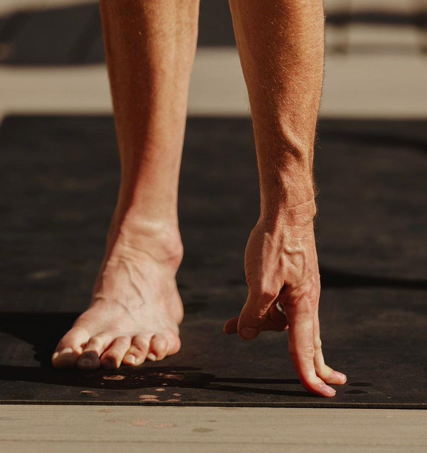 man practicing hot yoga on rituil non-slip, non-toxic black cork leather yoga mat