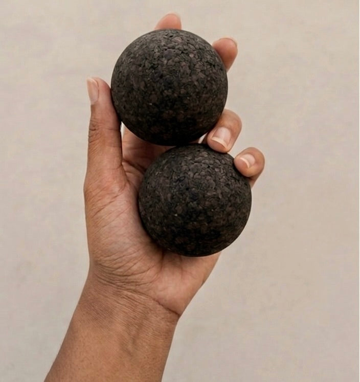 woman holding set of Rituil cork massage balls