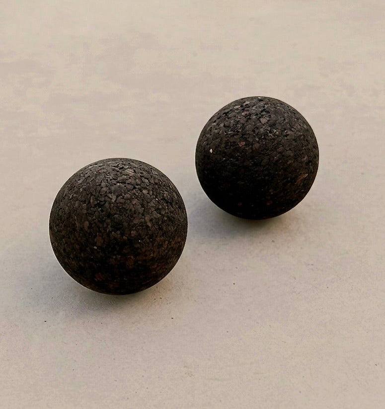 set of 2 cork massage balls on concrete floor