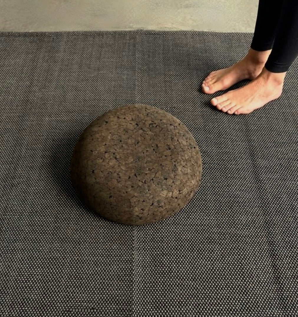 Cork meditation seat on top of cotton yoga rug