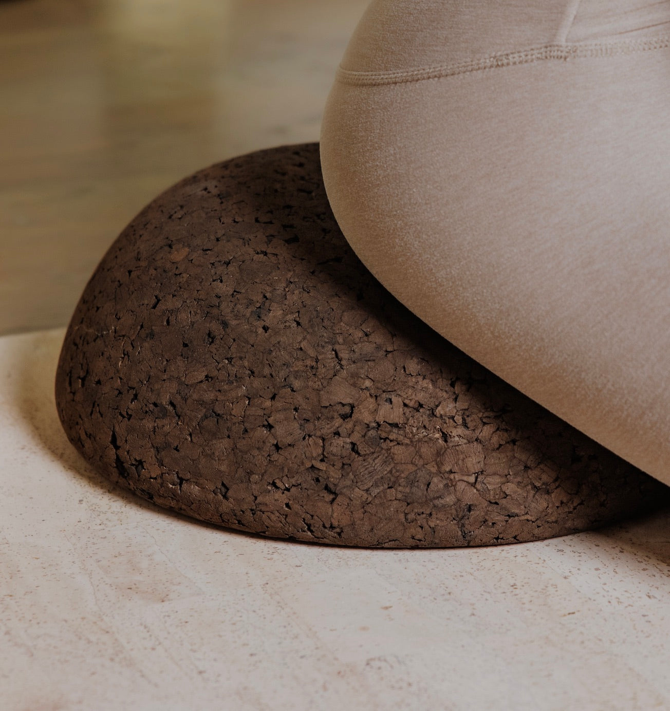 woman sitting on top of a cork meditation seat