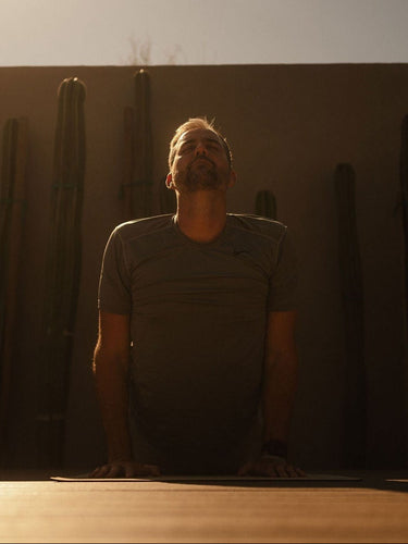 man practicing on rituil natural cork yoga mat