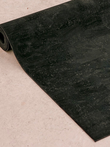 Rituil™ ash or black cork yoga mat detail image of mat rolled up #color_ash