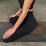 woman sitting on earth or brown cork meditation seat