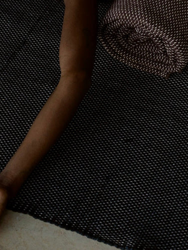 woman laying down on natural cotton yoga rug