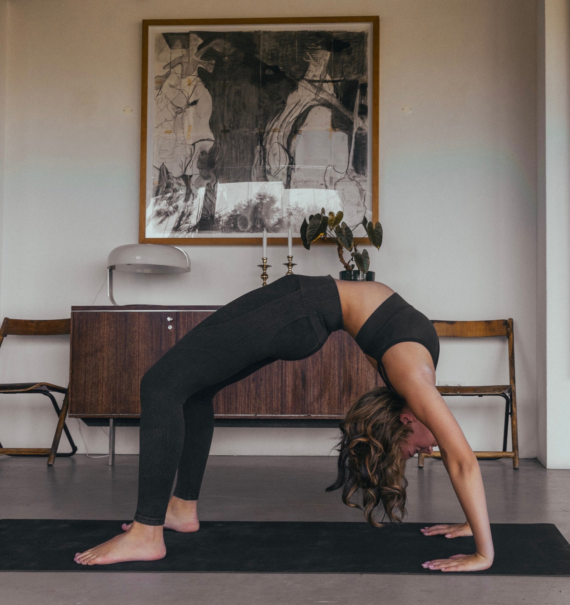 Rituil sustainable black cork leather yoga mat featuring a non-slip, non-toxic, pvc free, with woman in wheel yoga pose #color_ash