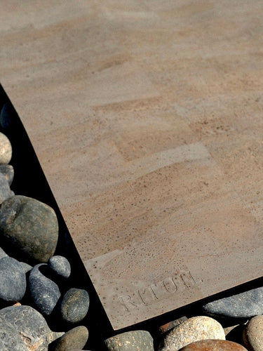 Rituil cork leather yoga mat laying on stone 
