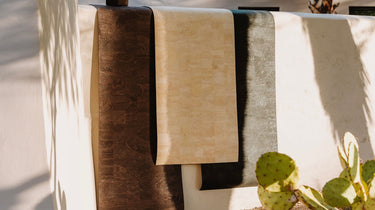 three hanging natural cork leather non slip yoga mats over a wall